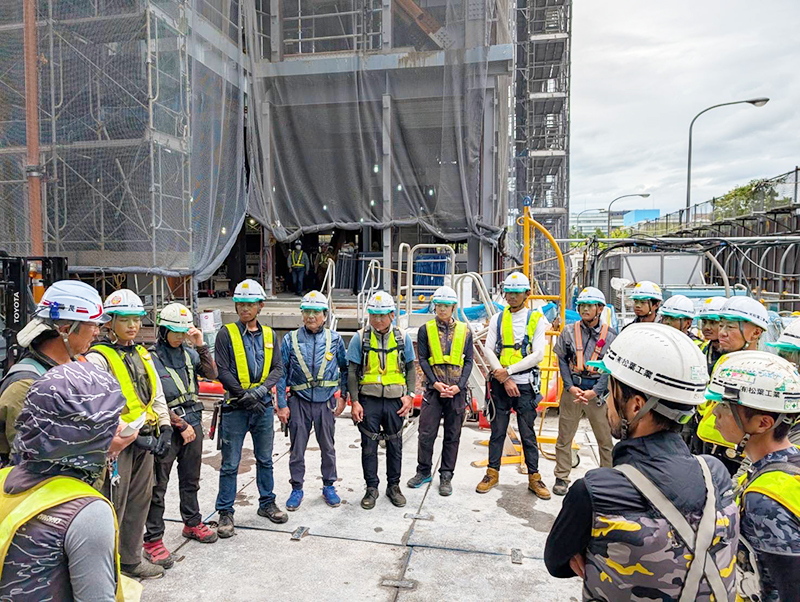 ヘルメットを持った作業員三人